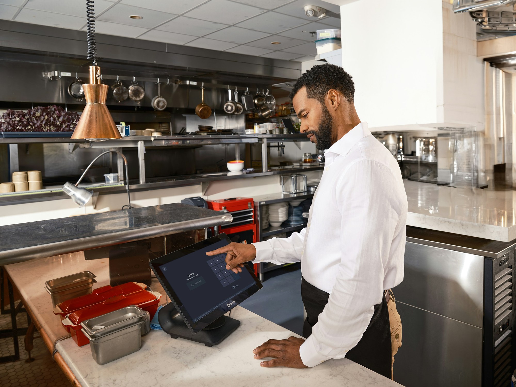 A restaurant owner using a touchscreen system