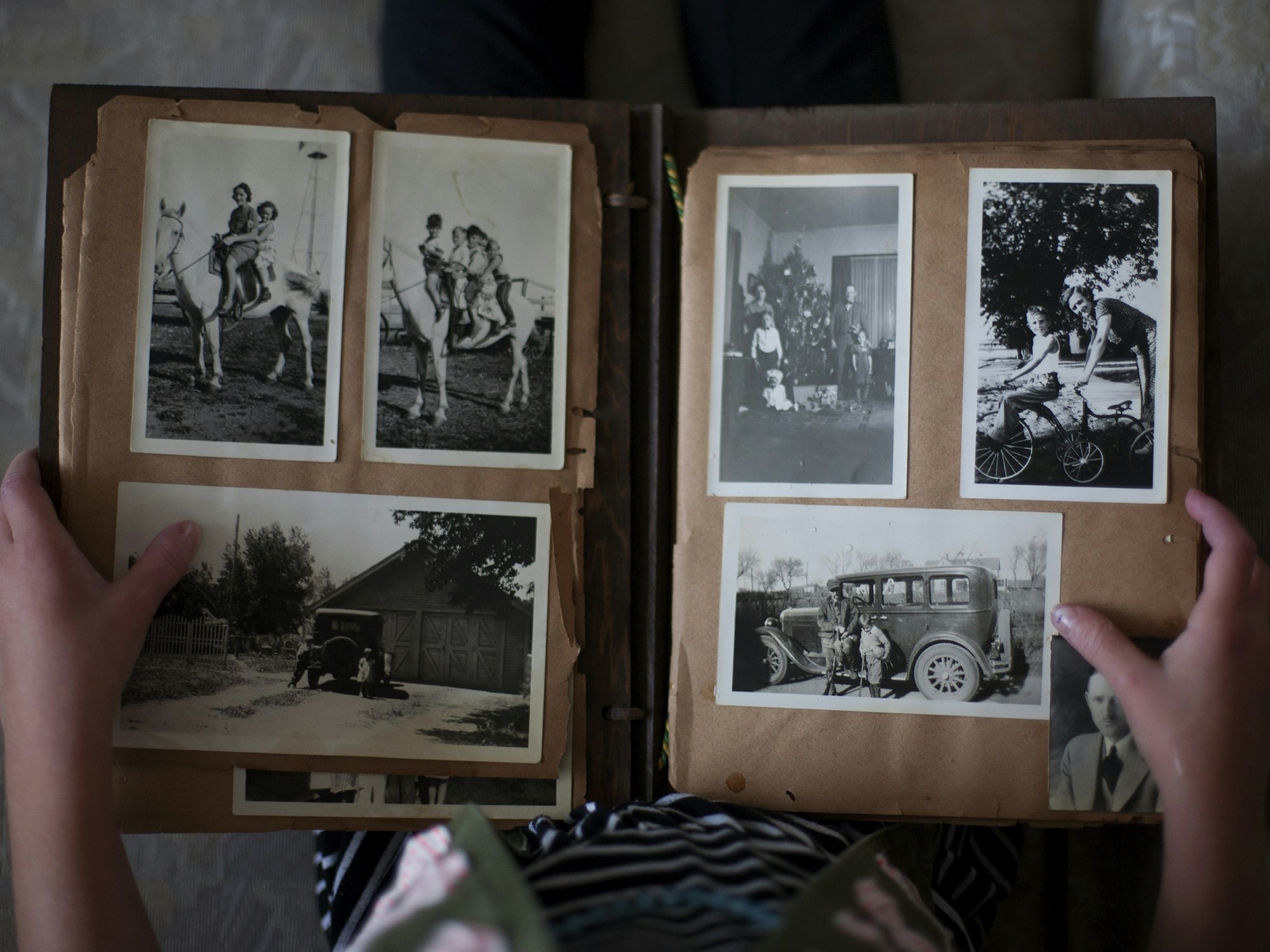 Hands turning the pages of a family photo album
