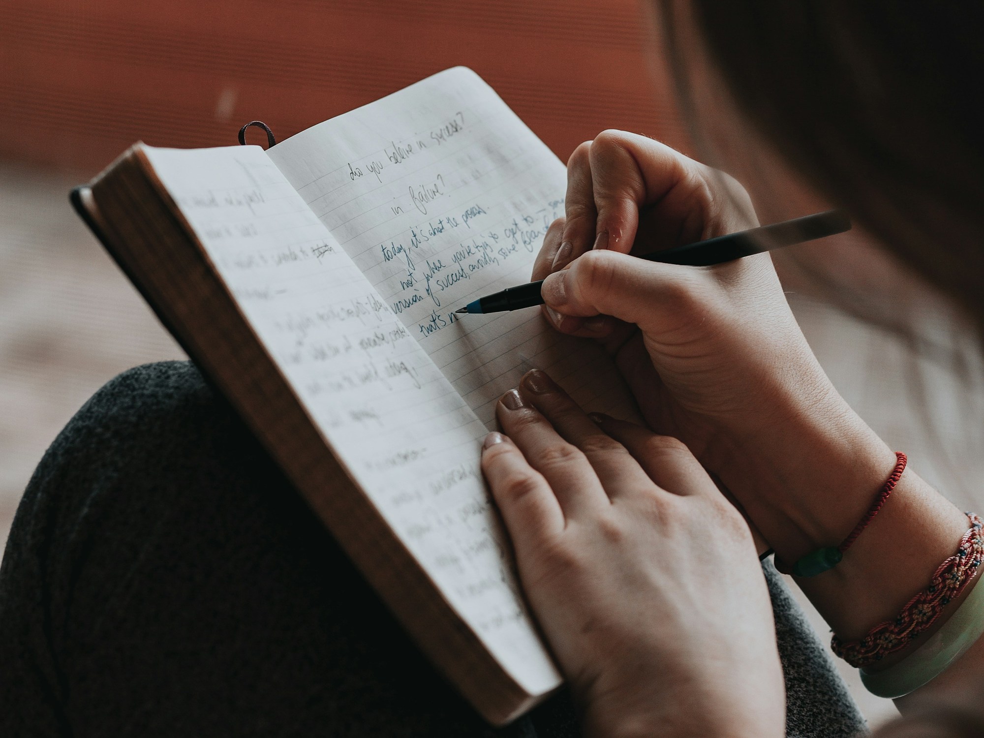 A writer drafting in a notebook