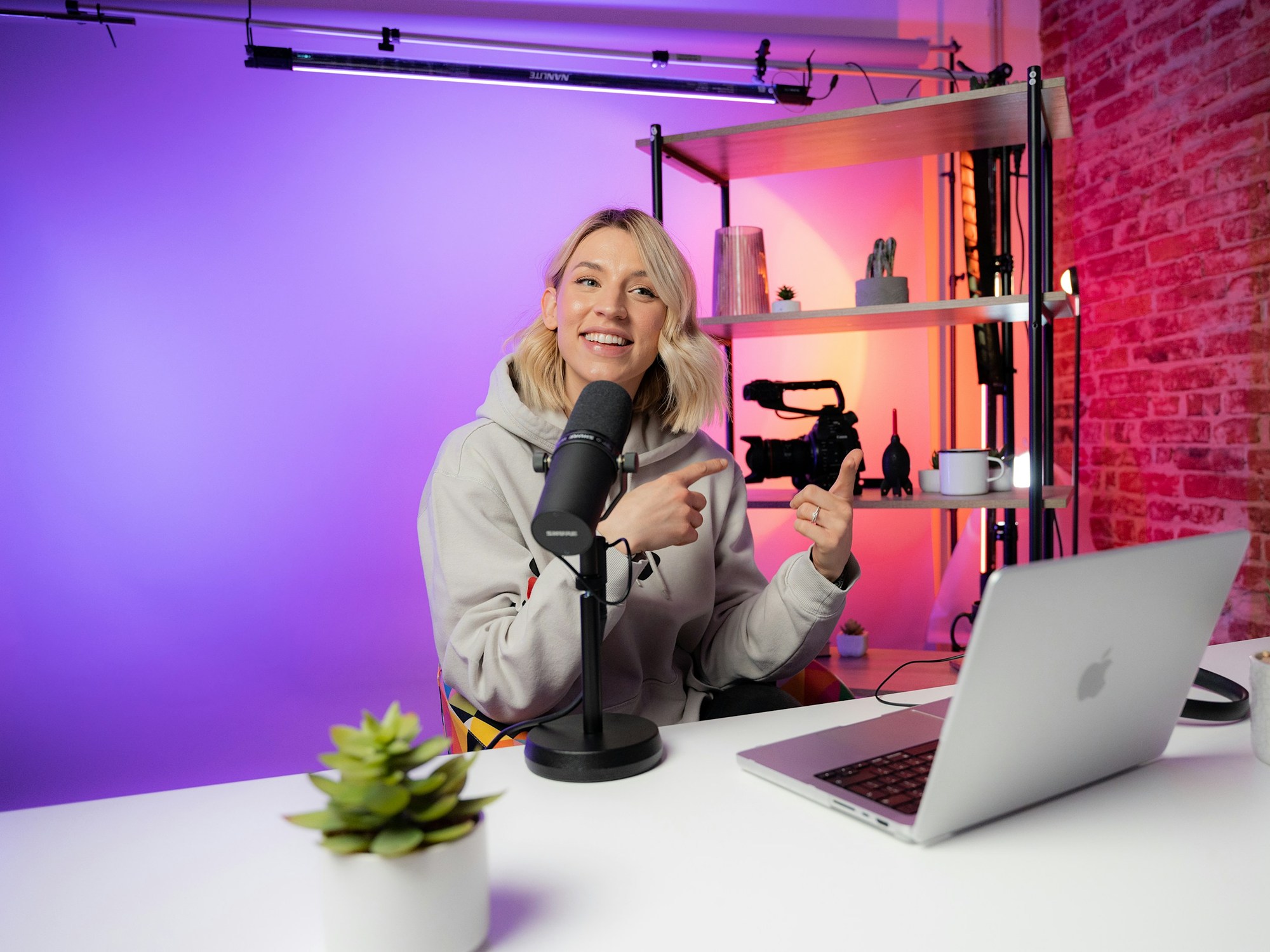 A content creator recording in a colorful studio