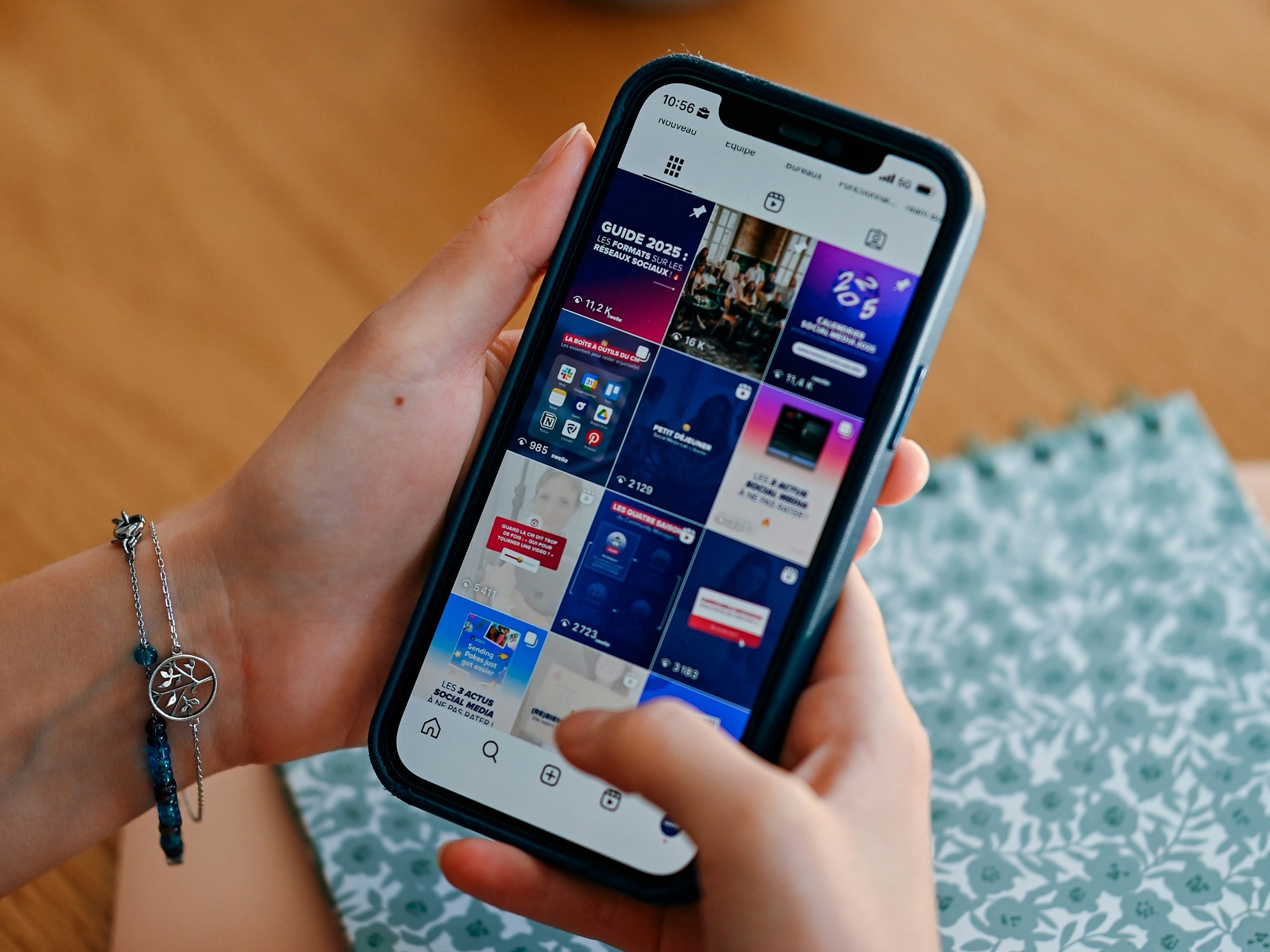 Hands holding a phone scrolling a feed