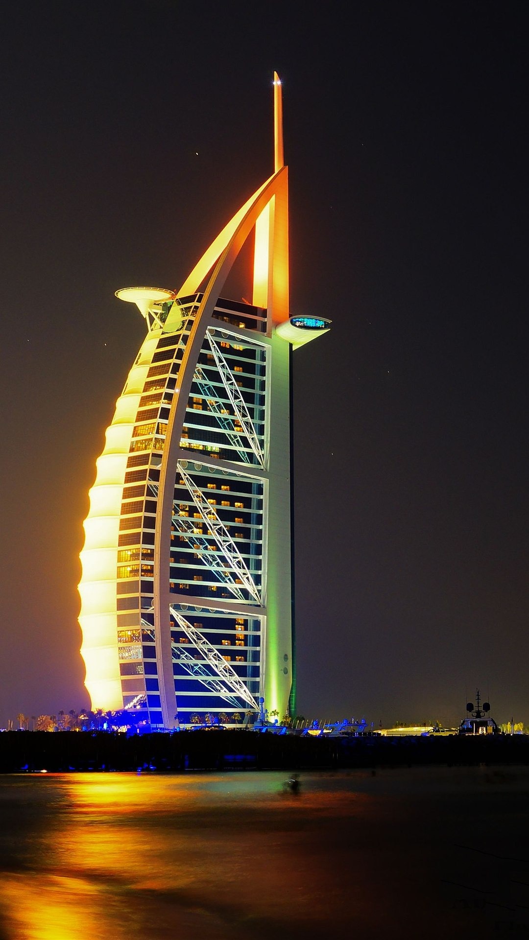 The Burj Al Arab lit gold at night